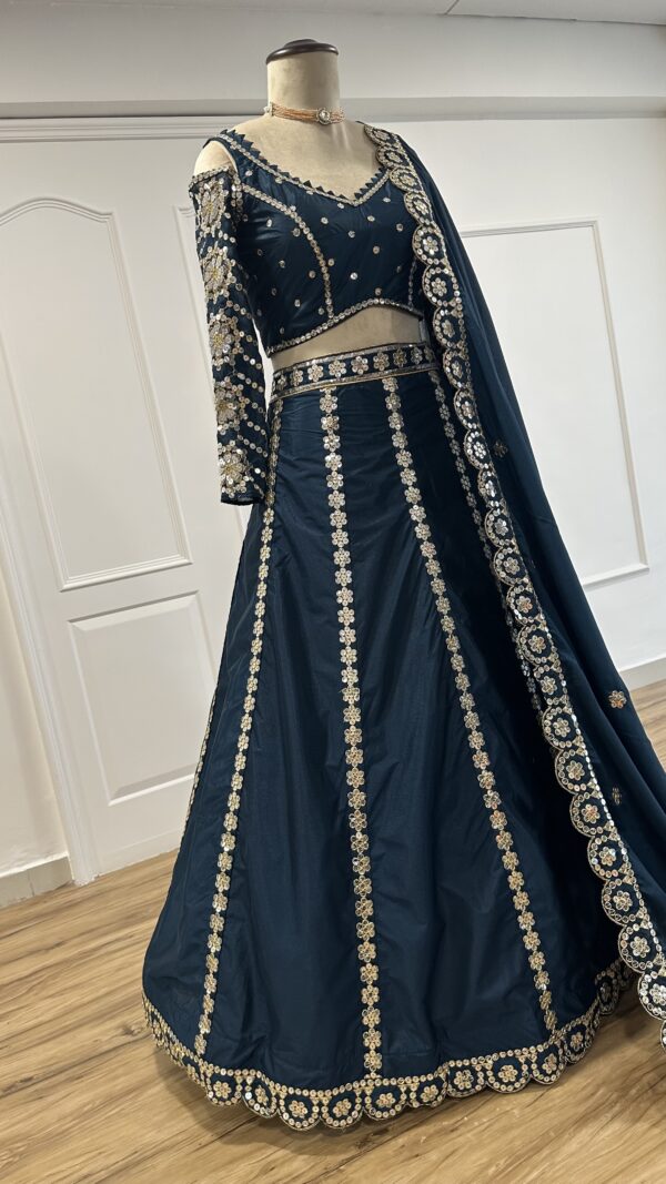 Royal teal designer lehenga with sequin zari border and can-can